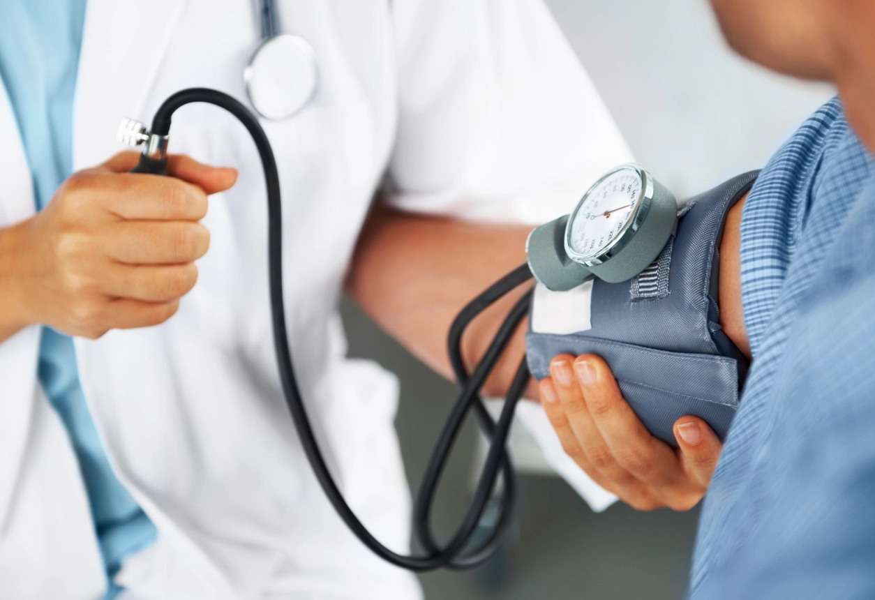 Doctor checking patient's blood pressure.