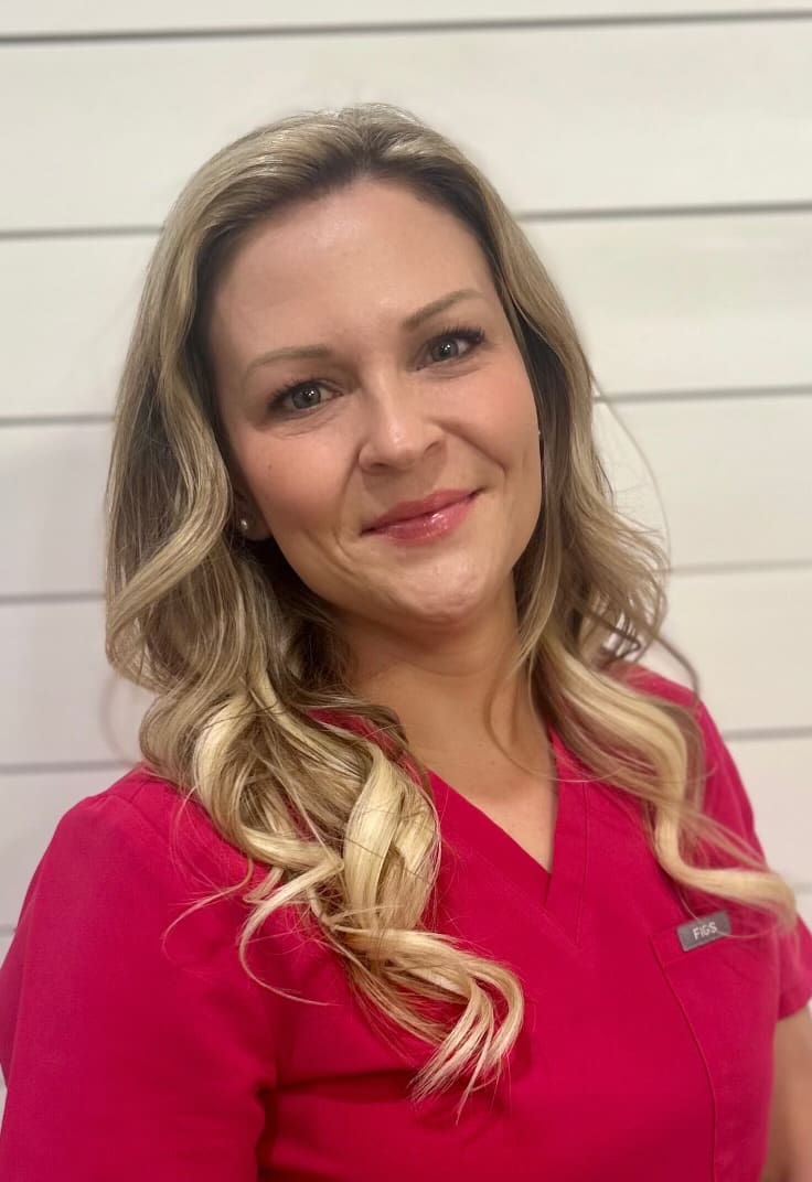 Smiling woman in red scrubs portrait